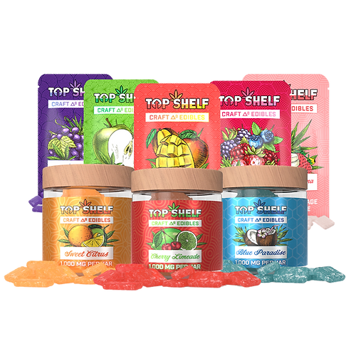 An assortment of colorful gummy candies with packaging indicating different flavors such as grape, green apple, mango, and wild berry.