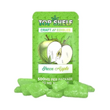 Green apple-themed cannabis edibles packaging with 'Top Shelf' branding on a white background.