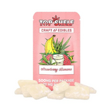 Pink packaging of Top Shelf Strawberry Banana edibles with illustrations of a banana, strawberry, and pineapple.