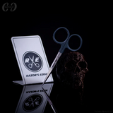 Scissors with 'Razor's Edge' branding on a reflective surface against a black background