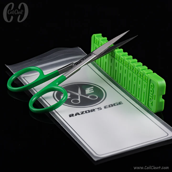 Green scissors and green plastic tool on a white card with 'Razor's Edge' branding.