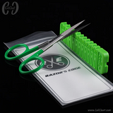 Green scissors and green plastic tool on a white card with 'Razor's Edge' branding.