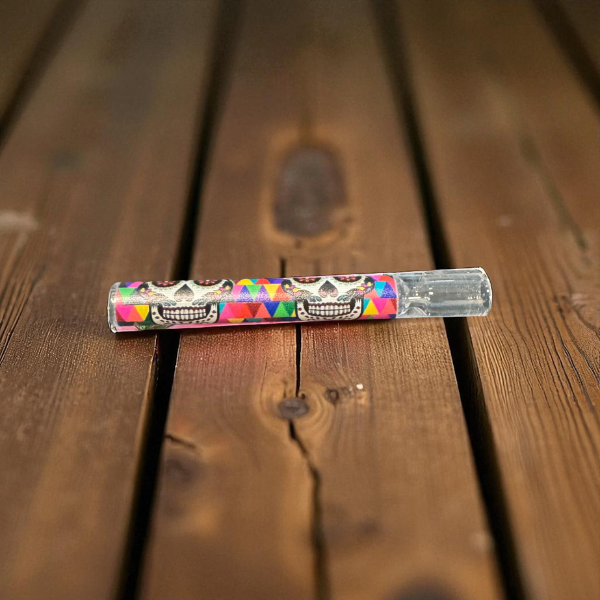 Colorful skull design on a metallic object on a wooden surface