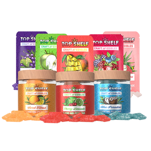 An assortment of colorful gummy candies with packaging indicating different flavors such as grape, green apple, mango, and wild berry.