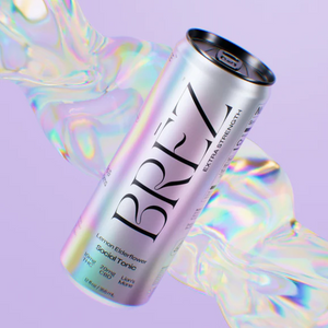 A can of BREZ sparkling beverage with lemon elderflower flavor, presented with a colorful, abstract background.