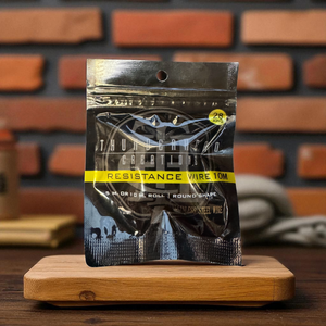 Packaged resistance wire on a wooden block with a brick wall background