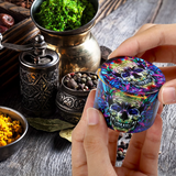 Colorful skull-patterned grinder held by a hand with various herbs and containers in the background.